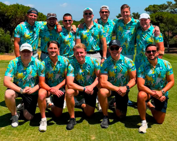 Golf group wearing matching turquoise tropical print polos on the course