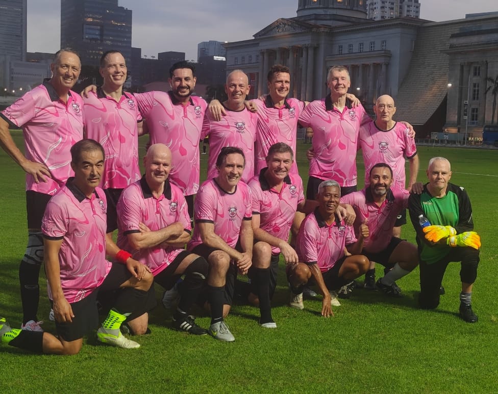 The HOGS FC squad in matching pink camo playing shirts